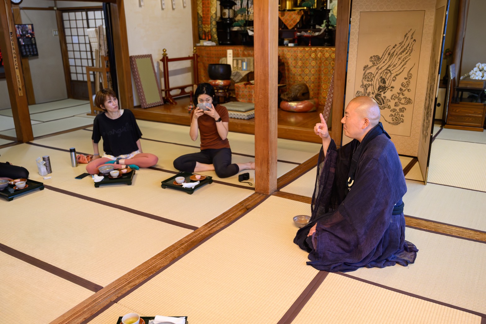 The head priest speaking with guests over Japanese tea after Temple Yoga