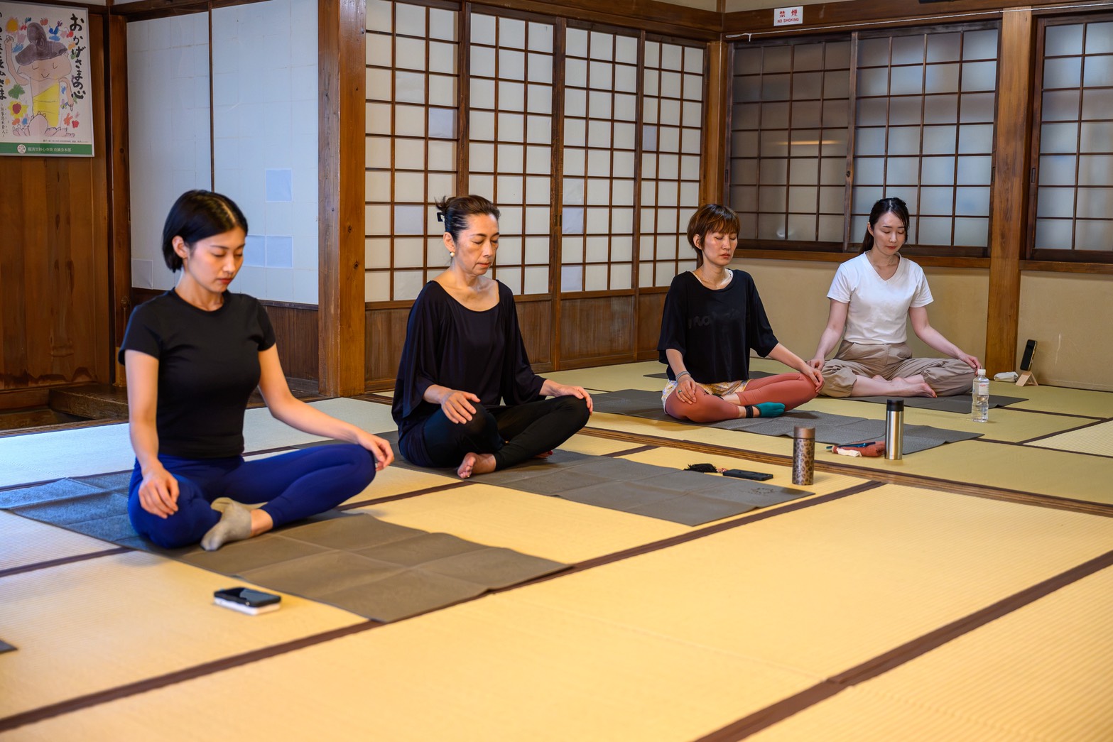 Guests sitting quietly in meditation at Kinryuji Temple, Asakusa
